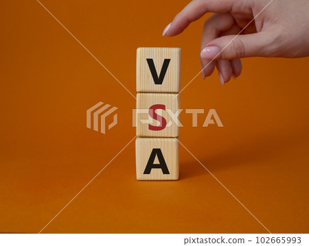 VSA - Volume Spread Analysis symbol. Wooden cubes with word VSA. Businessman hand. Beautiful orange background. Business and Volume Spread Analysis concept. Copy space. VSA - Volume Spread Analysis symbol. Wooden cubes with word VSA. Businessman hand. Beautiful orange background. Business and Volume Spread Analysis concept. Copy space. 102665993