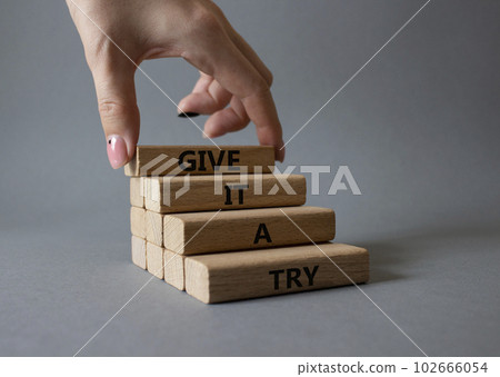 Give it a try symbol. Concept words Give it a try on wooden blocks. Beautiful grey background. Businessman hand. Business and Give it a try concept. Copy space. Give it a try symbol. Concept words Give it a try on wooden blocks. Beautiful grey background. Businessman hand. Business and Give it a try concept. Copy space. 102666054