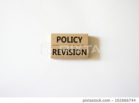 Policy revision symbol. Concept word Policy revision on wooden blocks. Beautiful white background. Business and Policy revision concept. Copy space 102666744