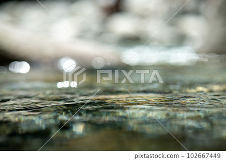 A clear stream in the mountains surrounded by nature 102667449