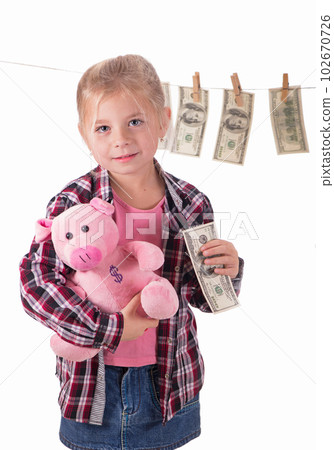 children and money. Girl with a piggy bank. Girl hanging dollar bills on a rope isolated on white background children and money. Girl with a piggy bank. Girl hanging dollar bills on a rope isolated on white background 102670726