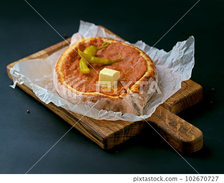 Khachapuri Georgian traditional cheese pie with feta mozzarella. Hand taking cheese pie Khachapuri Georgian traditional cheese pie with feta mozzarella. Hand taking cheese pie 102670727