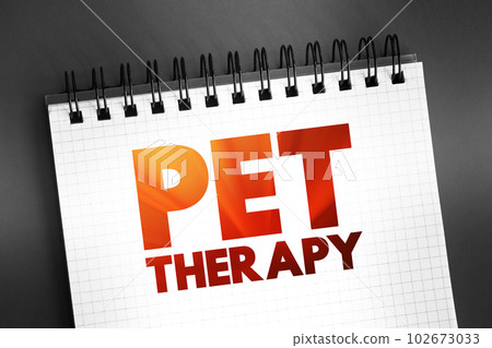 Pet therapy - guided interaction between a person and a trained animal, text concept on notepad 102673033