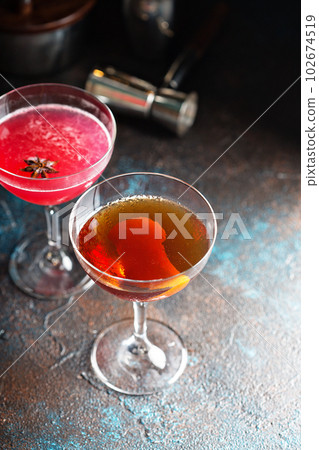Fall whiskey cocktail with orange zest 102674519
