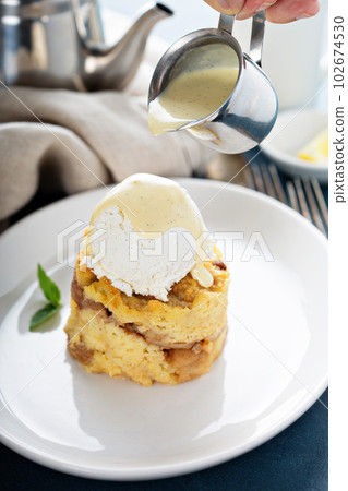 Apple bread pudding with vanilla ice cream 102674530
