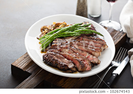 Beef steak with asparagus and mushrooms 102674543