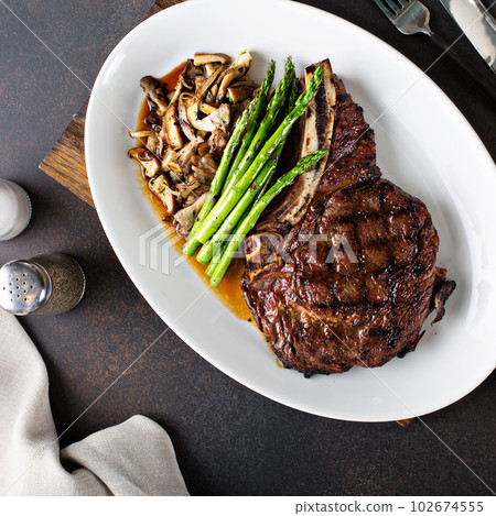 Beef steak with asparagus and mushrooms 102674555