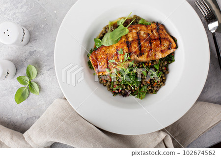 Grilled salmon with lentils and swiss chard Grilled salmon with lentils and swiss chard 102674562