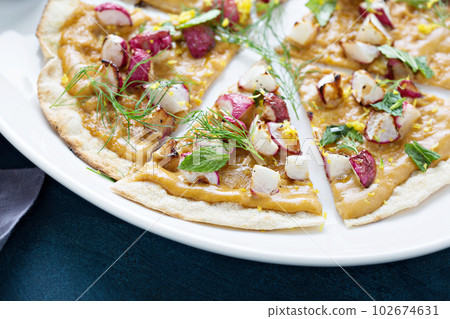 Flatbread or pizza with roasted radishes Flatbread or pizza with roasted radishes 102674631