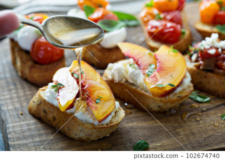 Crostini or bruschetta with ricotta and peaches Crostini or bruschetta with ricotta and peaches 102674740