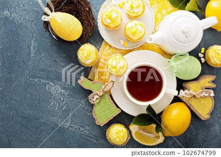 Lemon cupcakes with yellow frosting 102674799
