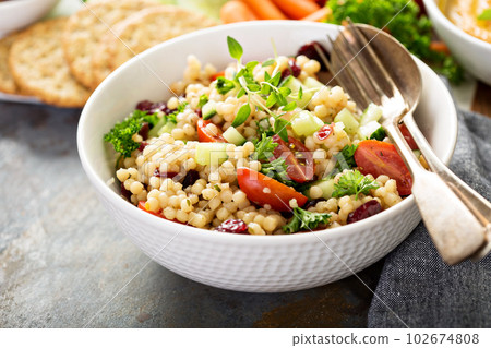 Pearl couscous salad with fresh vegetables Pearl couscous salad with fresh vegetables 102674808