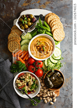 Hummus and vegetables platter with grain salad 102674815
