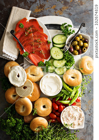 Big breakfast platter with bagels, smoked salmon and vegetables 102674819