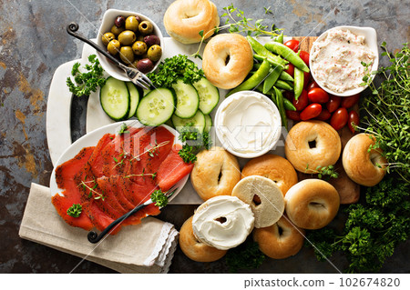 Big breakfast platter with bagels, smoked salmon and vegetables Big breakfast platter with bagels, smoked salmon and vegetables 102674820