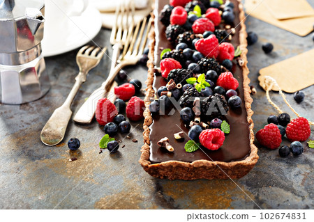 Chocolate ganache tart with fresh berries Chocolate ganache tart with fresh berries 102674831