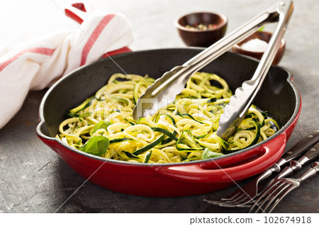 Spiralized zucchini noodles in a cast iron pan Spiralized zucchini noodles in a cast iron pan 102674918