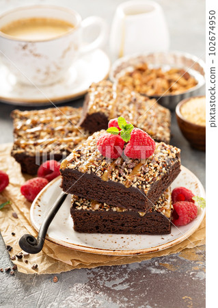 Fudgy brownies with nuts and caramel 102674950