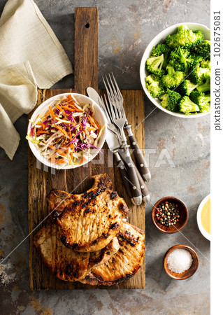 Grilled pork chops with cole slaw salad 102675081