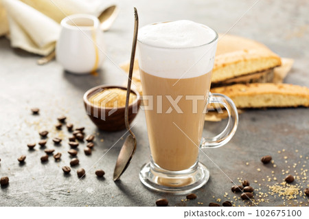Hot coffee latte with biscotti cookies 102675100