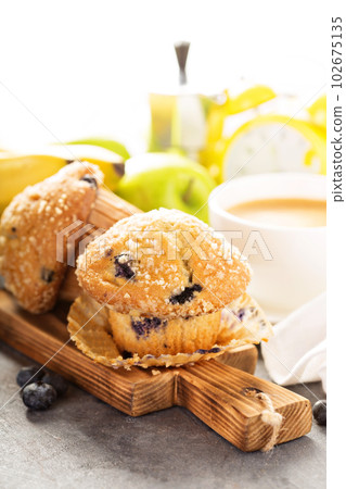 Blueberry and banana muffins with coffee for breakfast 102675135