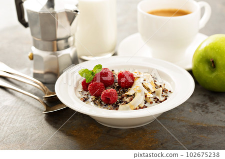 Quinoa porridge with raspberry and coconut flakes Quinoa porridge with raspberry and coconut flakes 102675238