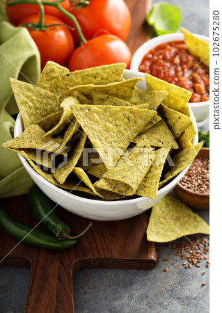 Healthy corn tortilla chips with spinach and flax seeds 102675280