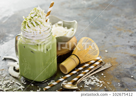 Iced matcha latte with coconut cream 102675412