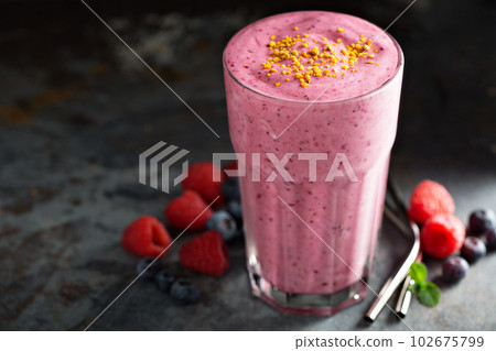 Berry smoothie in a tall glass Berry smoothie in a tall glass 102675799