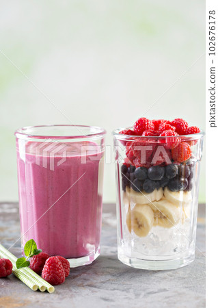 Berry smoothie ingredients in tall glass Berry smoothie ingredients in tall glass 102676178