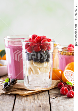 Berry smoothie ingredients in tall glass Berry smoothie ingredients in tall glass 102676179
