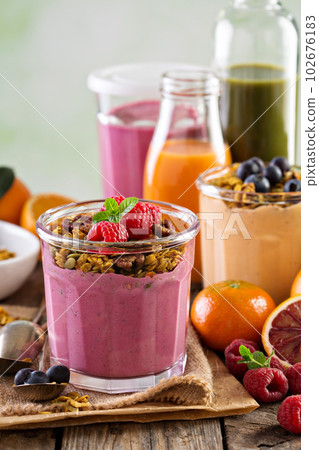 Healthy orange and raspberry smoothie 102676183