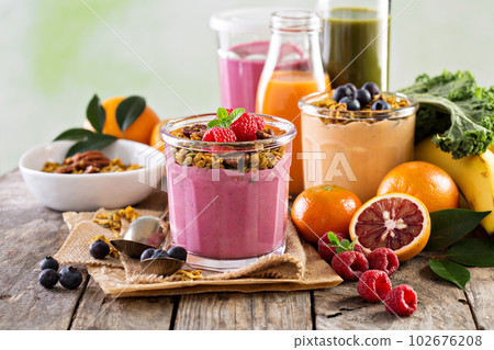 Healthy orange and raspberry smoothie 102676208
