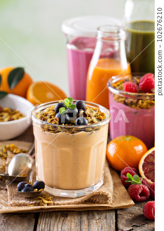 Orange mango smoothie with granola Orange mango smoothie with granola 102676210
