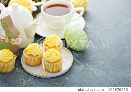 Lemon cupcakes with yellow frosting 102676250