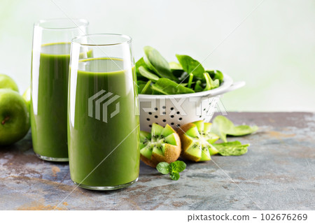 Green juice in tall glasses 102676269