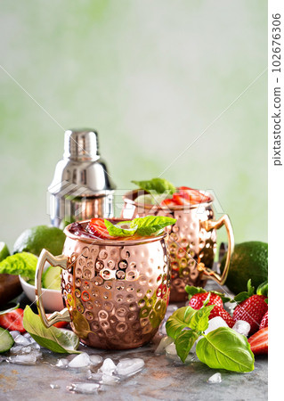 Moscow mule cocktail with lime and strawberry 102676306