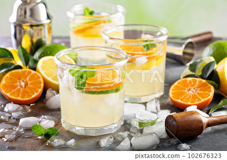 Refreshing summer cocktail with citrus fruits Refreshing summer cocktail with citrus fruits 102676323