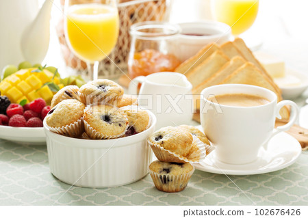 Fresh and bright continental breakfast table 102676426