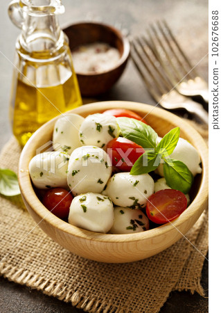 Fresh mozzarella marinated with herbs 102676688