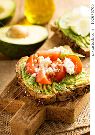 Avocado toast with tomatoes and feta 102676700