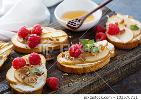 Pear bruschetta with cream cheese and honey Pear bruschetta with cream cheese and honey 102676711