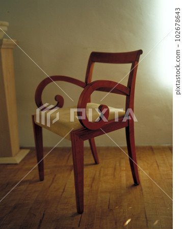 Garbo chair by Italian company Porada with soft light coming through the blinds in the living room Garbo chair by Italian company Porada with soft light coming through the blinds in the living room 102678643