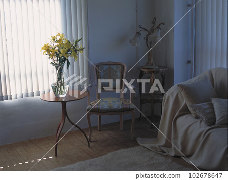 A living room with soft light coming in from the blinds, a sofa, a chair and a lily 102678647