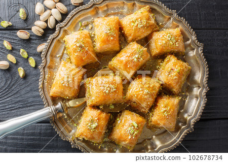 Turkish traditional delight baklava with pistachio on a wood background closeup. Horizontal top view 102678734