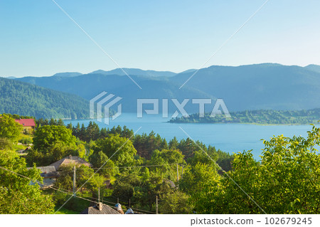 landscape of Lake Bicaz surrounded by mountains in Romania 102679245