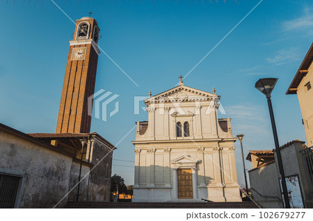 Old medieval cathedral with bell tower in the evening Old medieval cathedral with bell tower in the evening 102679277