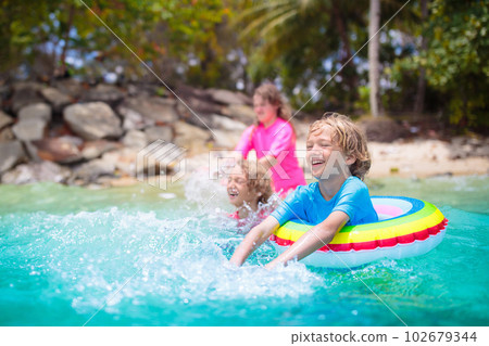 Kids playing on tropical beach. Summer fun. Kids playing on tropical beach. Summer fun. 102679344