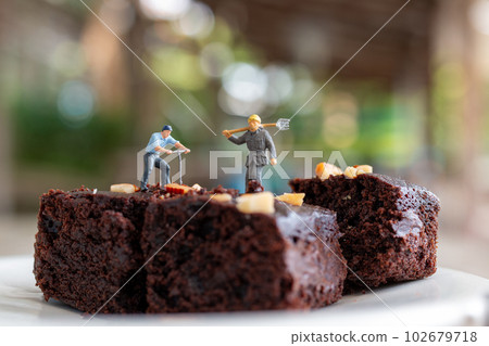 Miniature people, An employee is making a chocolate brownie Miniature people, An employee is making a chocolate brownie 102679718