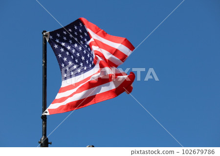 USA flag streaming in wind 102679786